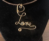 Love pendant on leather cord