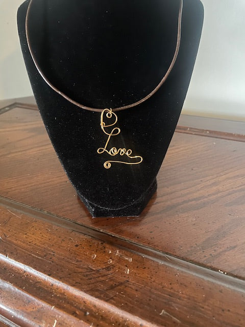 Love pendant on leather cord